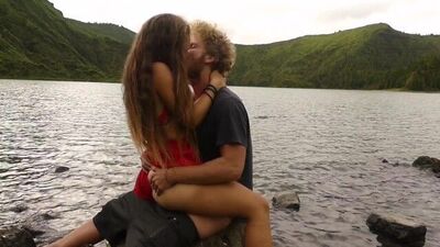 Horny couple pleasuring each other and making love passionately at a volcanic crater lake